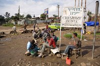 Boys young men and goats sitting by the roadside in Addis Ababa