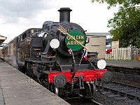 Steam engine with Pullman cars waiting at Sheffield Park station
